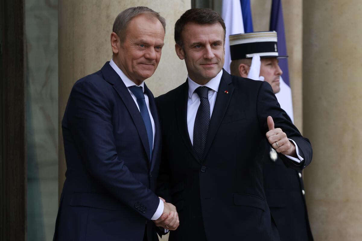 French President Emmanuel Macron, right, welcomes Poland's Prime Minister Tusk, Monday, Feb. 12, 2024 at the Elysee Palace in Paris. Poland's Prime Minister Donald Tusk was traveling to Paris and Berlin in a diplomatic effort to rebuild key alliances as fears grow that former President Donald Trump could return to power in the United States and give Russia a free hand to expand its aggression in Europe. (AP Photo/Aurelien Morissard)