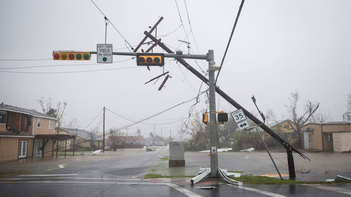 A snapped power pole leans against a stoplight after Hurricane Harvey ripped through Rockport, Texas. (Nick Wagner / Associated Press)