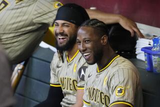 San Diego Padres' Jurickson Profar, right, and Fernando Tatis Jr. share a laugh in the dugout prior to a baseball game against the Arizona Diamondbacks Friday, May 3, 2024, in Phoenix. (AP Photo/Ross D. Franklin)