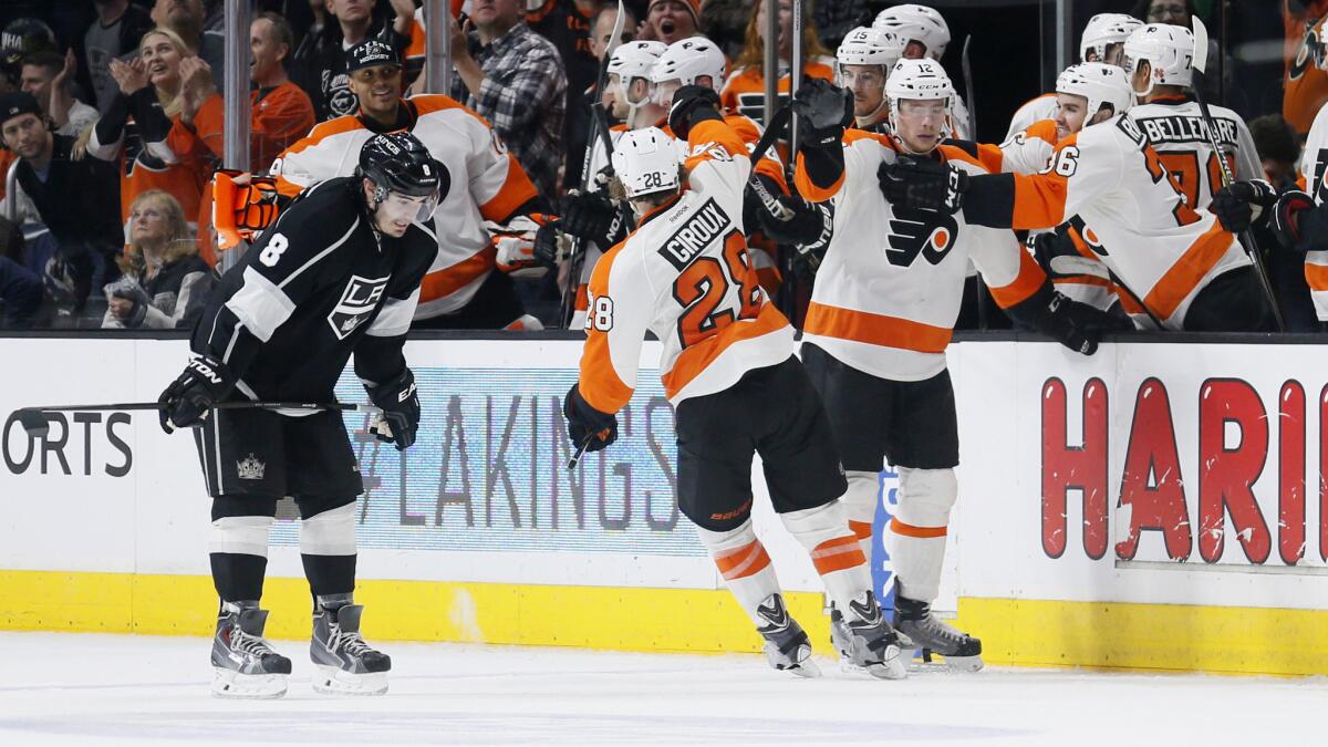 Philadelphia Flyers celebrate their 2-1 victory as Kings defenseman Drew Doughty, left, skates off the ice at Staples Center on Dec. 6.