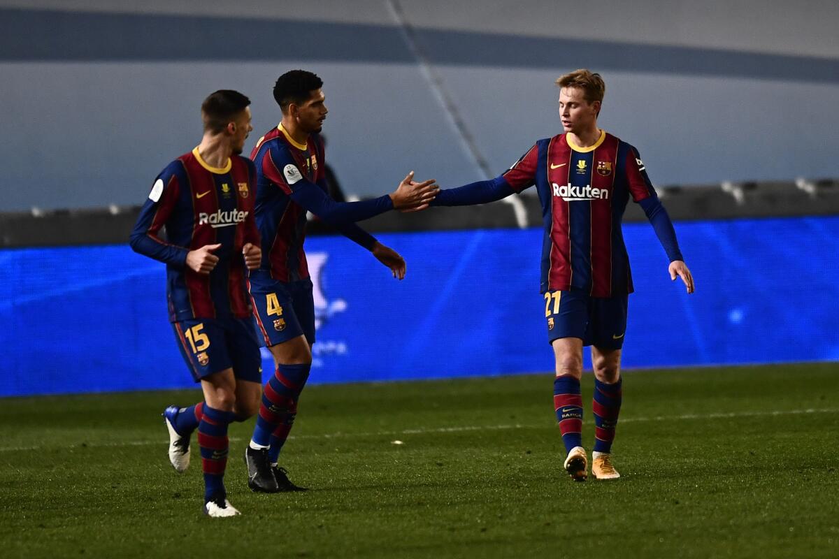 Barcelona's Frenkie de Jong celebrates with teammate Ronald Araujo after scoring.
