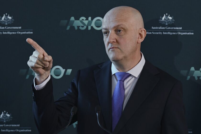 Australian Security Intelligence Organization director-general Mike Burgess points as he talks in Canberra, Australia, Monday, Nov. 28, 2022. Australia’s terrorism threat level has been downgraded from “probable" to “possible” for the first time since 2014, the head of Australia’s main domestic spy agency said on Monday. (Mick Tsikas/AAP Image via AP)