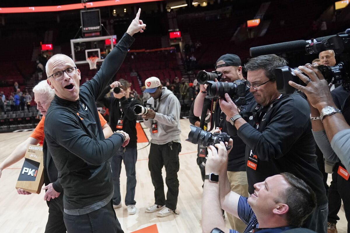 Connecticut head coach Dan Hurley celebrates after his team won the Phil Knight invitational championship game following an NCAA college basketball game Sunday, Nov. 27, 2022, in Portland, Ore. (AP Photo/Rick Bowmer)