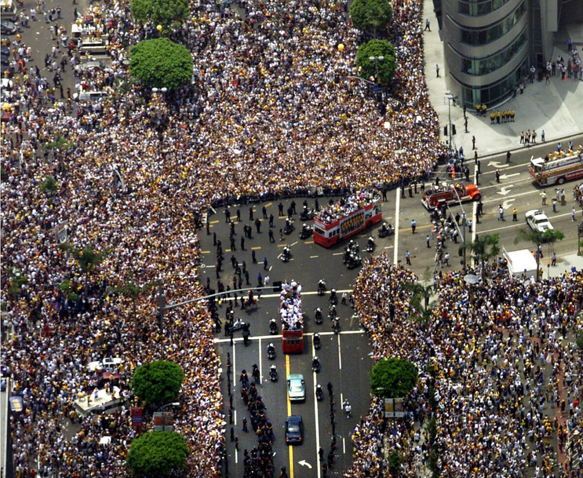 Throngs of fans crowd the streets during a Lakers parade in 2000. (Lori Shepler / Los Angeles Times)