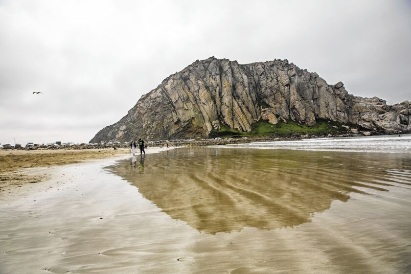 Craggy, dome-shaped Morro Rock, rising 576 feet above the shore, is a landmark on California's Central Coast.