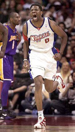 Forward Walter McCarty lets out a roar after a slam dunk during the third quarter of the Clippers' 102-83 victory over the Lakers.