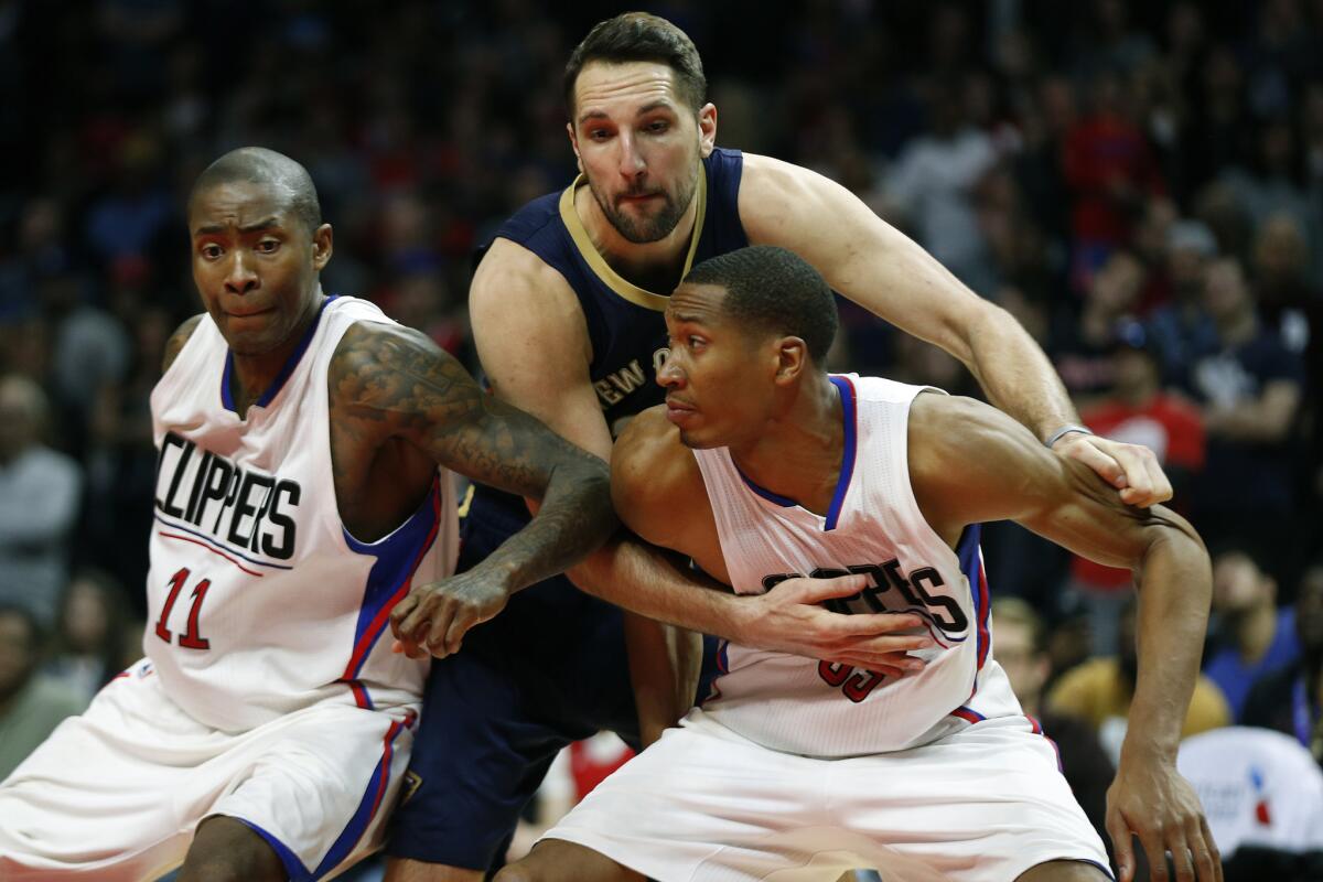 Pelicans forward Ryan Anderson fouls Clippers forward Wesley Johnson late in overtime while battling for rebounding position.