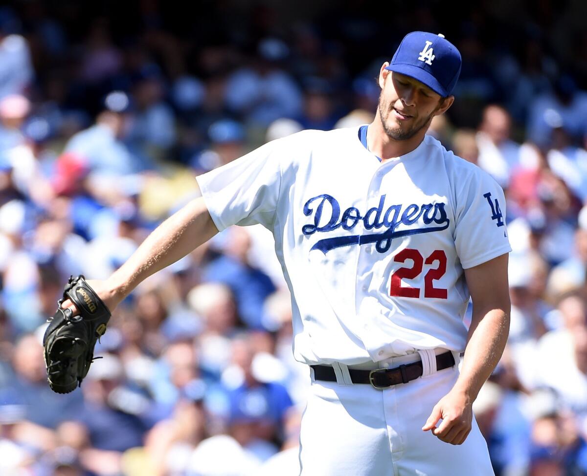 Dodgers ace Clayton Kershaw reacts after hitting San Diego leadoff batter Wil Myers with a pitch to open the season Monday at Dodger Stadium.