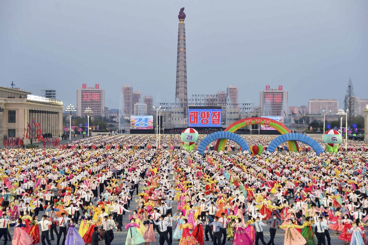 People dance in the celebration of the birth anniversary of late state founder Kim Il Sung, at the Kim Il Sung Square in Pyongyang, North Korea, Friday, April 15, 2022. (Kyodo News via AP)