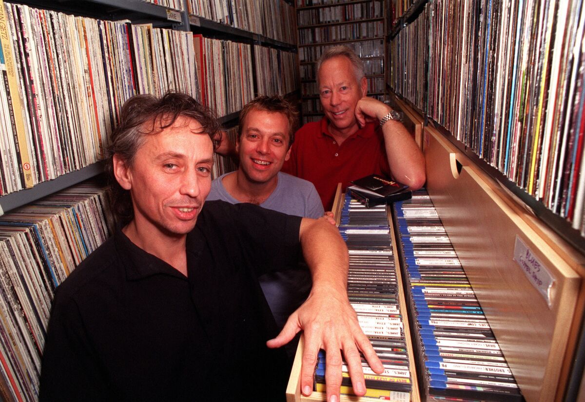 Previous KCRW music directors, from left, Nic Harcourt, Chris Douridas and Tom Schnabel in the music library at the station's basement studio.