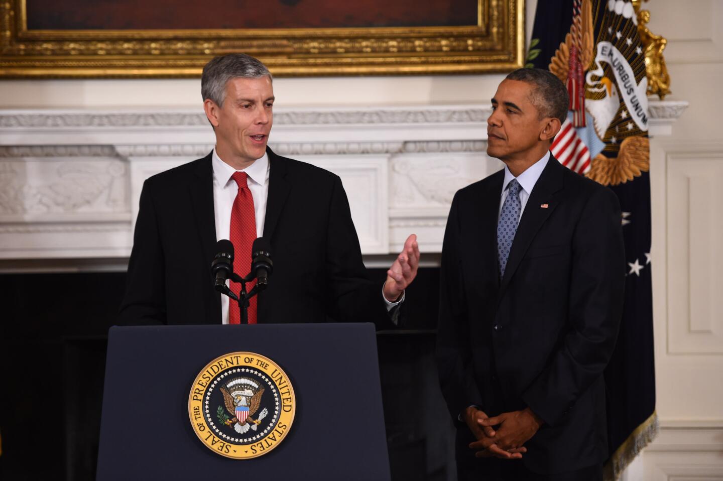 President Barack Obama listens as outgoing Education Secretary Arne Duncan speaks during a news conference at the White House on Oct. 2, 2015. Obama nominated John King Jr. to replace Duncan.