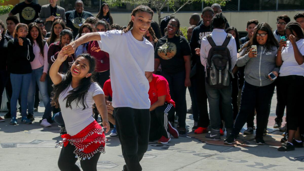 Two students dance in the quad area at Santee Education Complex.