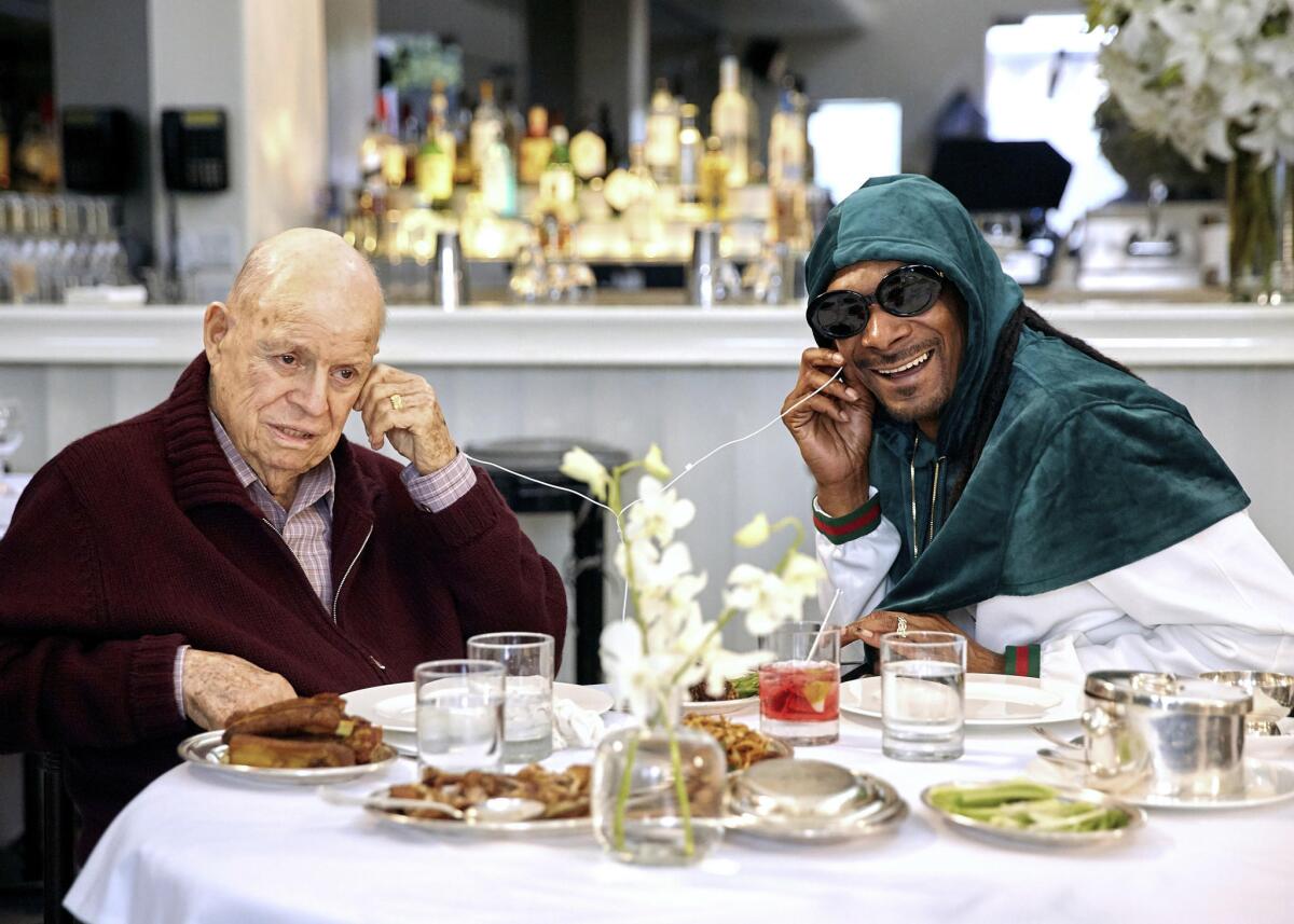 Don Rickles, left, and Snoop Dogg listen to music during an episode of "Dinner With Don."