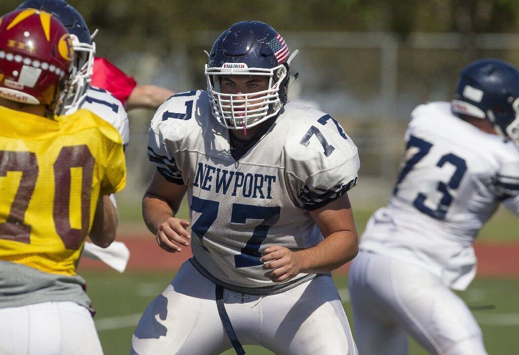 Newport Harbor High lineman Max Spruill, center, prepares to block during a scrimmage against Estancia at Jim Scott Stadium on Friday.