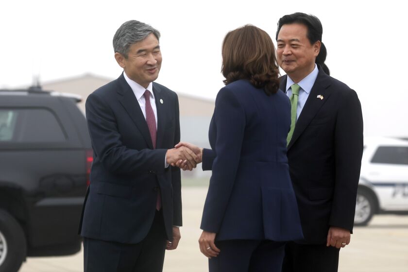 U.S. Vice President Kamala Harris, center, shakes hands with South Korean Ambassador to the U.S. Cho Tae-Yong, at Osan Air Base, in Pyeongtaek, South Korea, Thursday, Sept. 29, 2022.(Leah Millis/Pool Photo via AP)