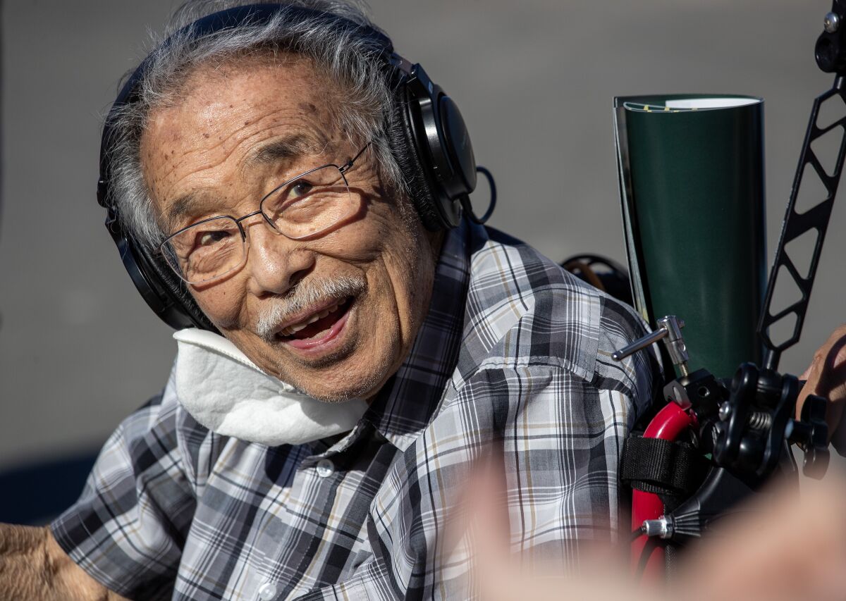 Min Tonai listens while on a tour of Santa Anita Park