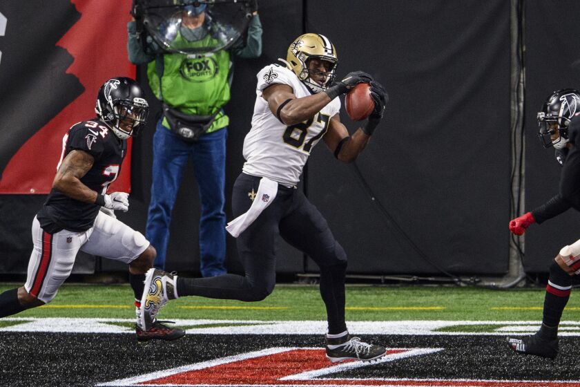 New Orleans Saints tight end Jared Cook (87) catches a pass for a touchdown as Atlanta Falcons defensive back Darqueze Dennard (34) defends during the first half of an NFL football game, Sunday, Dec. 6, 2020, in Atlanta. (AP Photo/Danny Karnik)