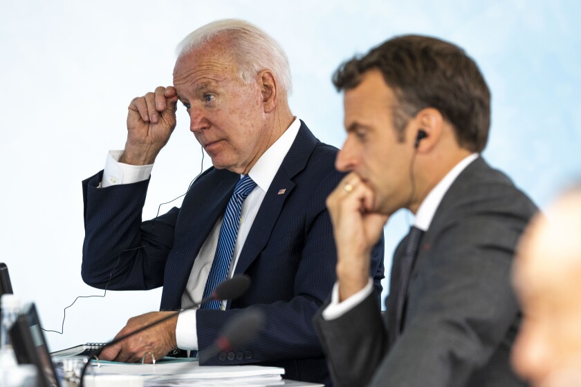 President Joe Biden talks with French President Emmanuel Macron during the final session of the G-7 summit in Carbis Bay, England, Sunday, June 13, 2021. (Doug Mills/The New York Times via AP, Pool)