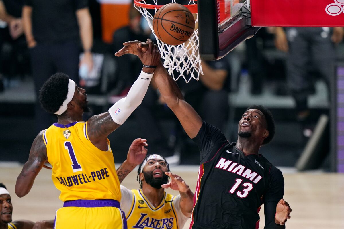 Lakers guard Kentavious Caldwell-Pope battles Heat center Bam Adebayo for a rebound during Game 1.