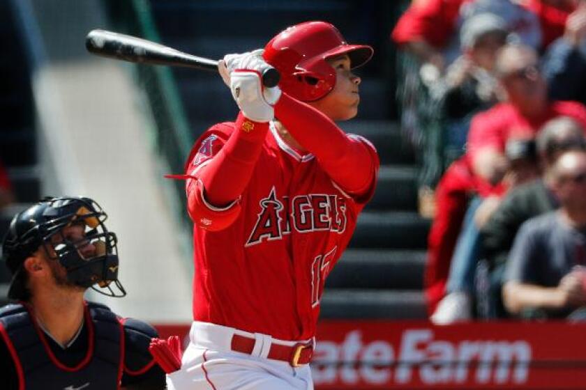 Angels designated hitter Shohei Ohtani (17) hits a 2-run homer.