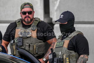 Immigration and Customs Enforcement officers stand at the scene where a man was shot in his vehicle by an ICE officer, Sunday, Sept. 20, 2026, in Austin, Texas. (Aaron E. Martinez /Austin American-Statesman via AP)