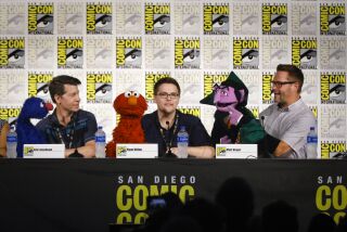 Sesame Street cast members, Eric Jacobson, left with Grover, Ryan Dillon, with Elmo, and Matt Vogel, right, who is the Count, during the Sesame Street at 50 panel discussion on day three of the Comic-Con International Convention, July 20, 2019, at the San Diego Convention Center, in San Diego, California.