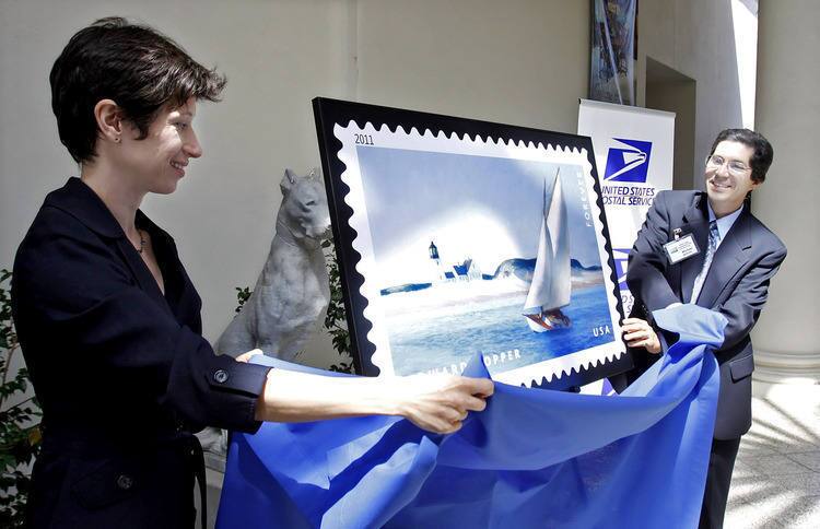Jessica Todd Smith, Virginia Steele Scott Chief Curator of American Art, The Huntington, left, and Michael Madrigal, United States Postal Service Manager of Retail, right, unveil a large copy of Edward Hopper's "The Long Leg" commemorative postage stamp at the Huntington Library, Art Collections, and Botanical Gardens in San Marino on Wednesday, August 24, 2011. The United States Postal Service held a brief ceremony to unveil the new stamp at the Huntington.