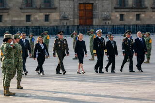 Mexican President Claudia Sheinbaum walks with Secretary of Security Omar García Harfuch and others