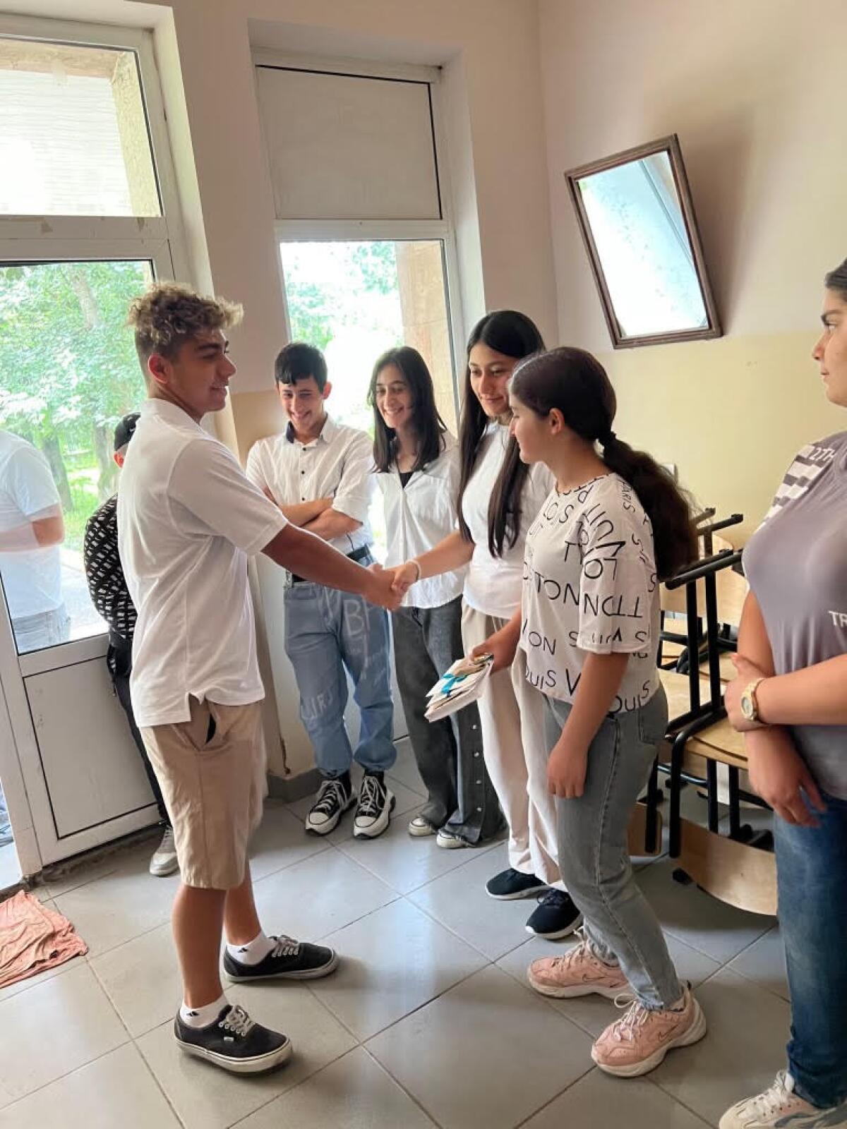 Loyola High water polo player Chris Petrossian meet students at a school in Armenia.