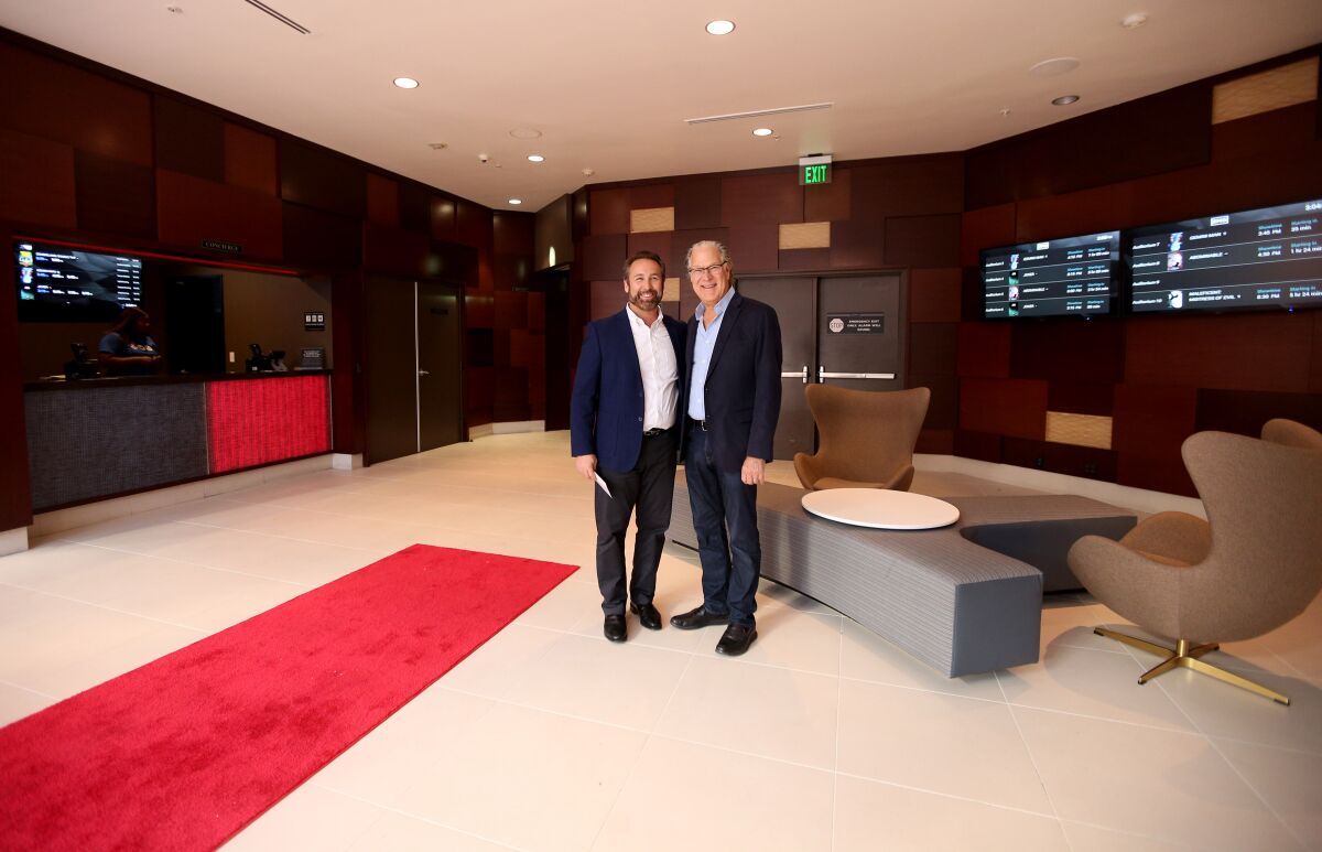 CEO and owner Brian Schultz, left, and board member Michael Lambert at the grand opening of Studio Movie Grill's Glendale location on Oct. 17.