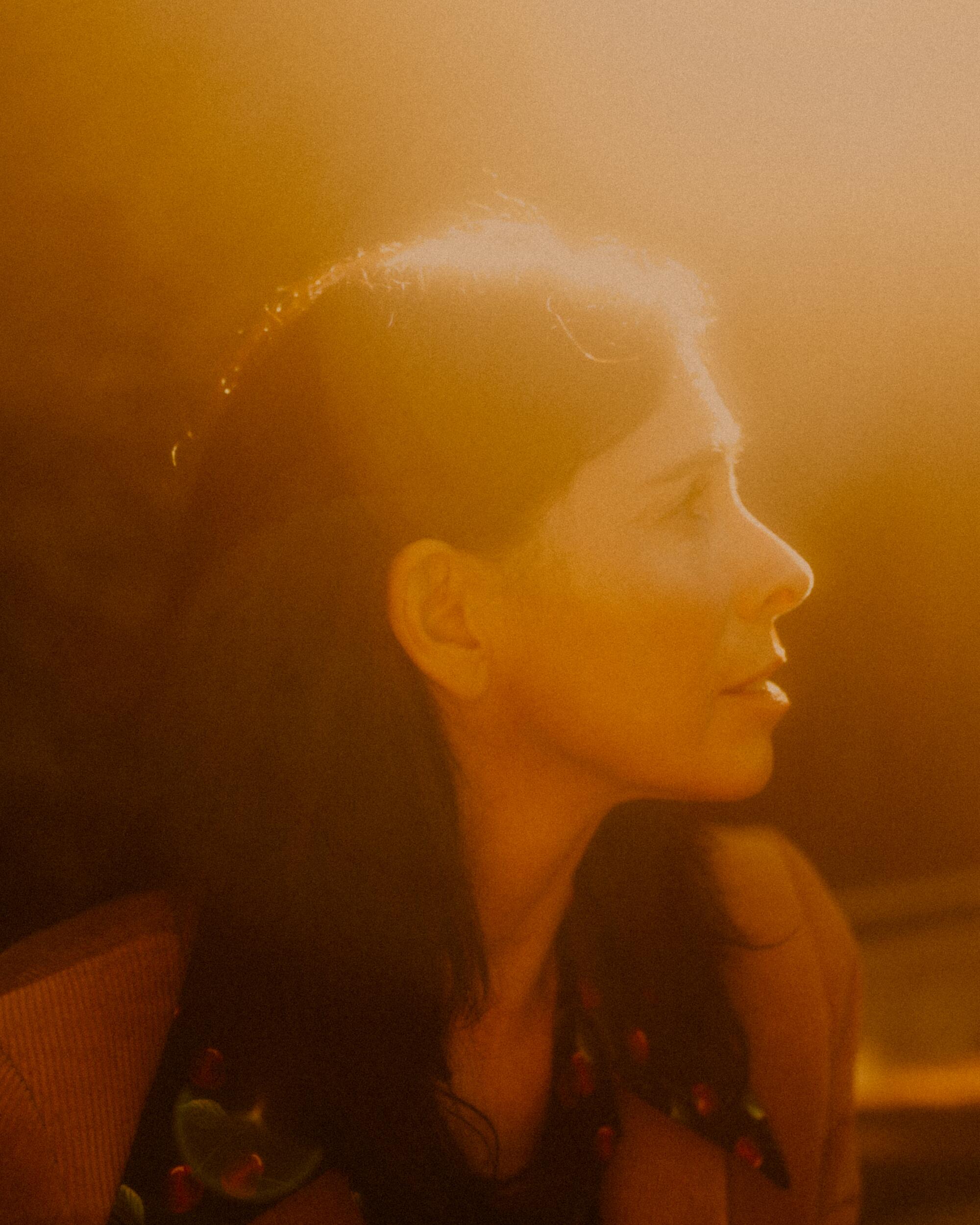 A profile shot of Sarah Silverman cast in golden sunlight. 