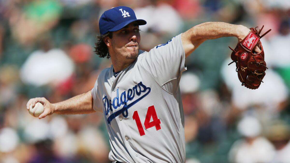Dodgers starter Dan Haren delivers a pitch during the fourth inning of Saturday's game against the Colorado Rockies.