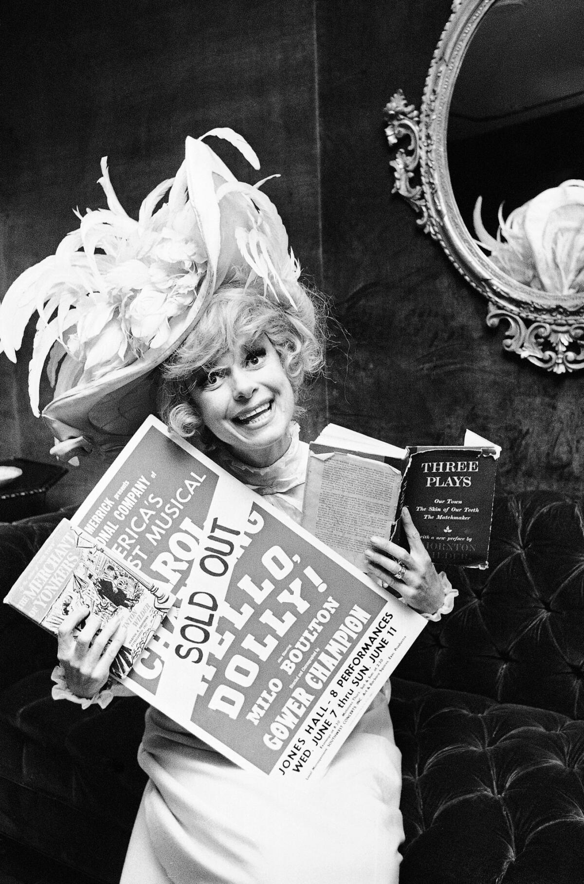 Channing in 1967, displaying a poster noting that "Hello, Dolly!" had sold out in Houston.