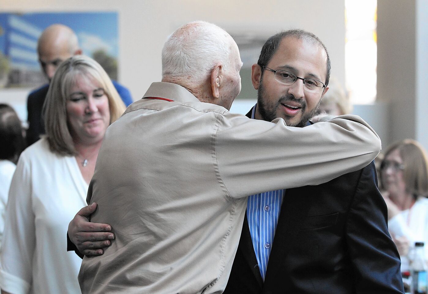 Cardiologist Salman Azam, right, greets his patient Lloyd Spencer during Edward Lifesciences Patient Day on Friday in Irvine. Nurse Susan Robinson, who helped on the surgery, is at far left. Spencer received a transcatheter heart valve.