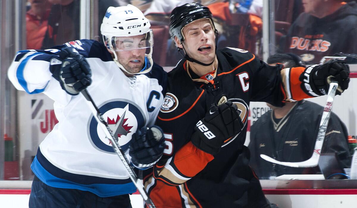 Ducks' Ryan Getzlaf is pushed by Jets' Andrew Ladd during the first period of Game One of the Western Conference semifinals at Honda Center on Thursday.