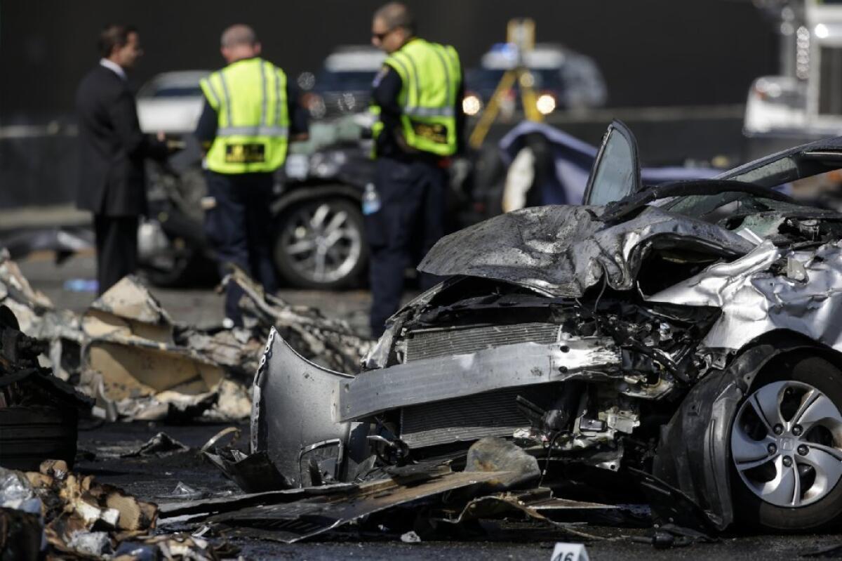 California Highway Patrol investigators probe the scene of a fiery crash on the 5 Freeway that left three people dead in Commerce earlier this year. Police believe the wreck was due to illegal street racing.