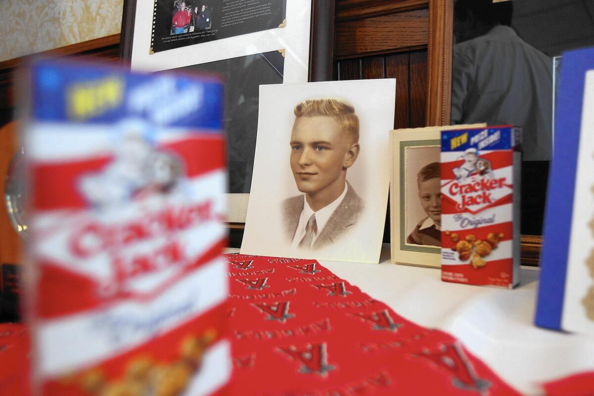 A high school picture of Jim de Boom adorns a memorial table next to his favorite Cracker Jacks snack during his celebration of life at the Balboa Pavilion on Wednesday.