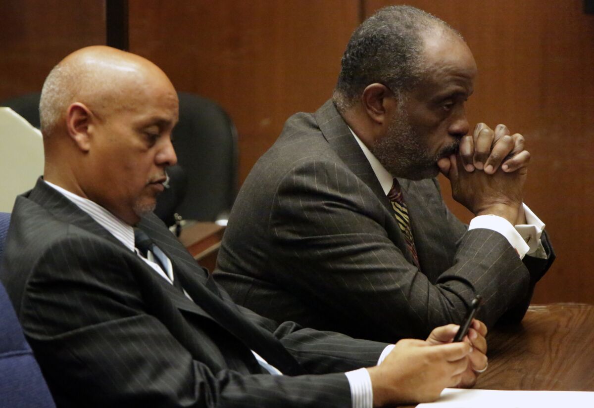 Then-state Sen. Roderick D. Wright, on right, listens to the judge on Jan. 28, shortly after a jury convicted him on eight felony counts.