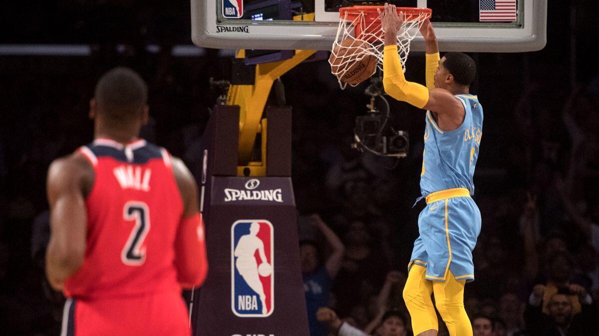 Lakers guard Jordan Clarkson, right, slams a dunk as Washington Wizards guard John Wall looks during the first half on Wednesday.