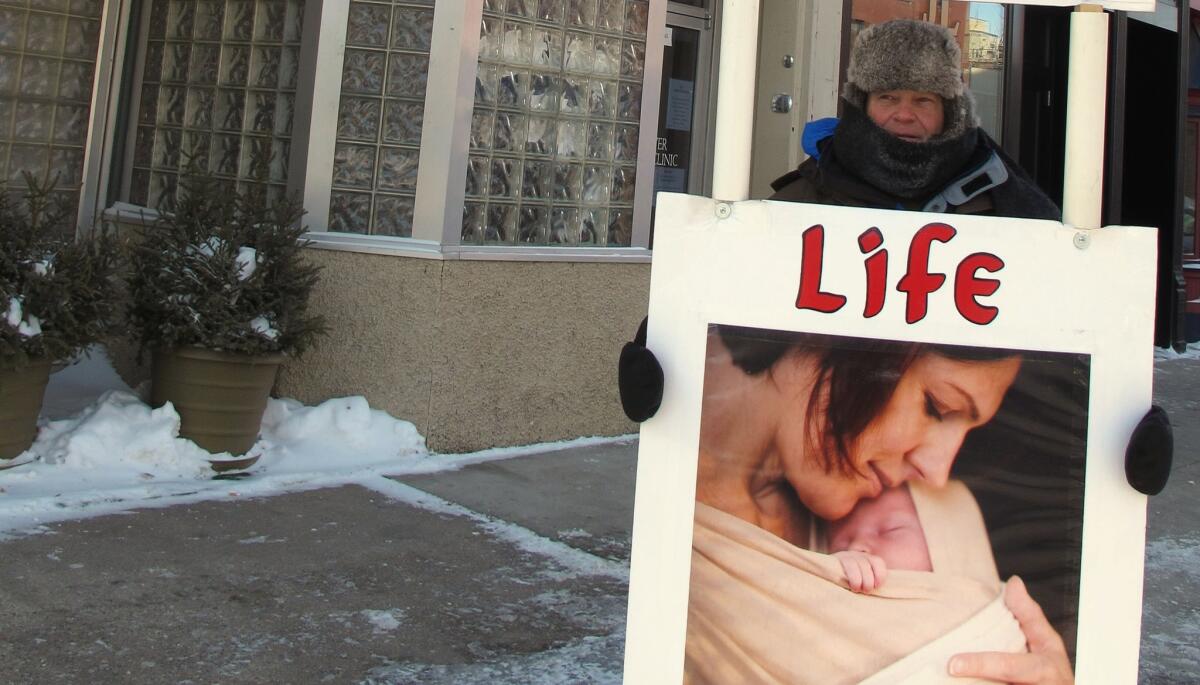 An abortion protester outside the Red River Women's Clinic in Fargo, N.D., in 2013.