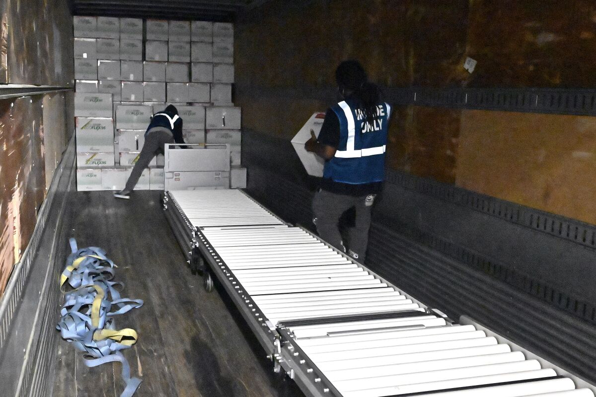FILE - The first boxes of the Johnson & Johnson COVID-19 vaccine are loaded into a truck for shipment from the McKesson facility in Shepherdsville, Ky., Monday, March 1, 2021. As demand for COVID-19 vaccines collapses in many areas of the U.S., states are scrambling to use stockpiles of doses before they expire and have to be added to the millions that have already gone to waste. (AP Photo/Timothy D. Easley, Pool, File)