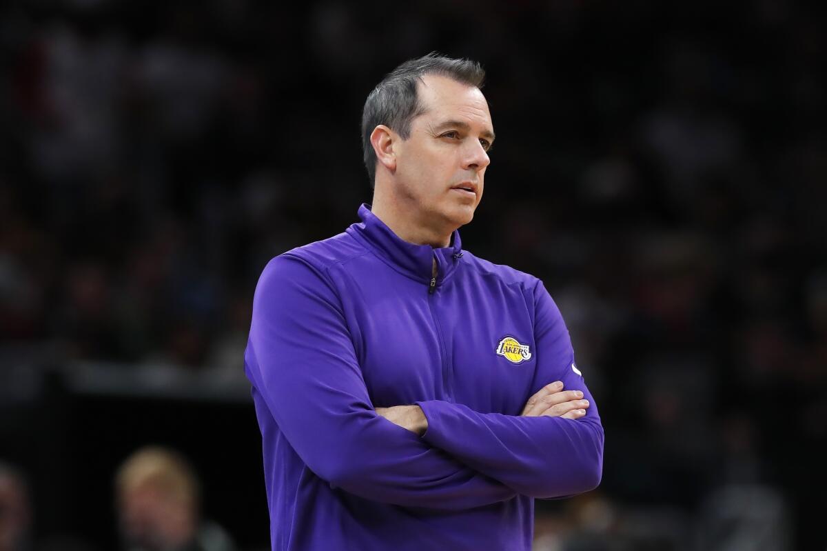 Lakers coach Frank Vogel looks on during a game with his arms folded