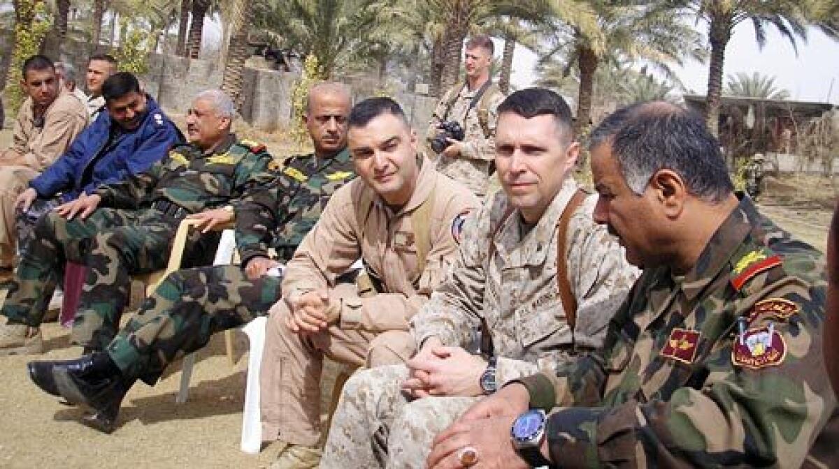 Iraqi Major-Gen. Tariq Abual Wahab Jasim, far right, and Marine Col. Robert F. Castellvi, second from right, have a common goal: get the Iraqi army ready to stand alone so that Americans can home. Castellvi acts as senior military advisor to Jasim, commanding general of the 1st Iraqi Army Division. They are shown at a feast hosted by a powerful Sunni tribal sheik and work closely together every day.