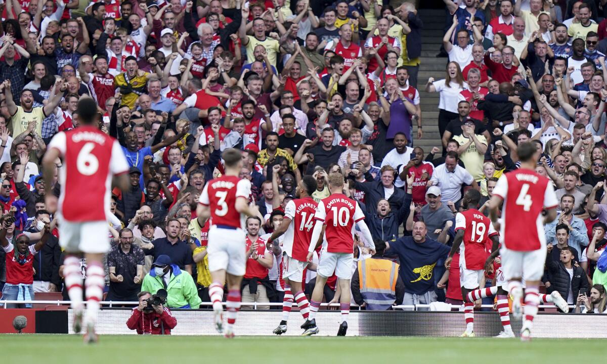 Arsenal's Pierre-Emerick Aubameyang, center, celebrates scoring their side's first goal of the game during their English Premier League soccer match at The Emirates Stadium, London, Saturday, Sept. 11, 2021. (Tess Derry/PA via AP)