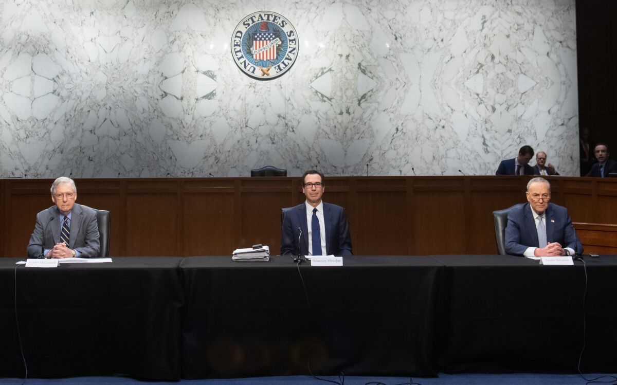 Sen. Mitch McConnell, left, Treasury Secretary Steven Mnuchin and Sent. Chuck Schumer at a meeting Friday to try to come up with an economic response to the coronavirus. 