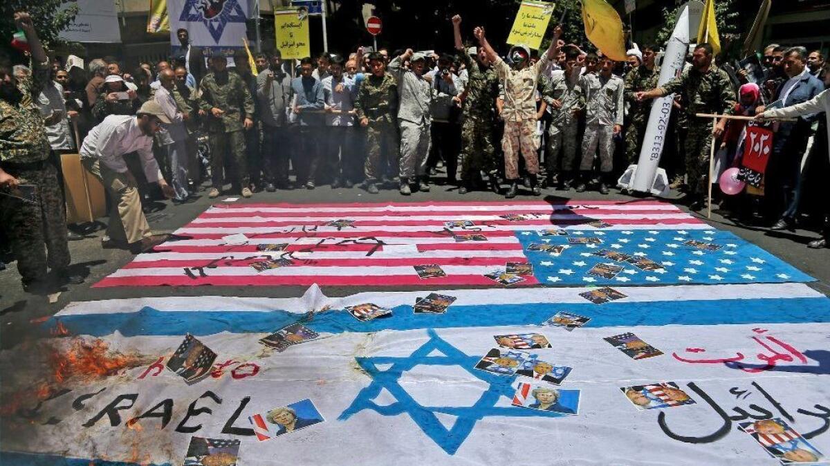 Iranian protesters burn representations of U.S. and Israeli flags and pictures of U.S. and British heads of state and Israel's prime minister in their annual pro-Palestinian rally.