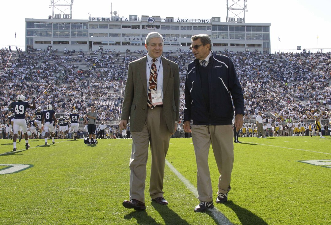 Penn State president Graham Spanier, left, and football coach Joe Paterno chat before a game.