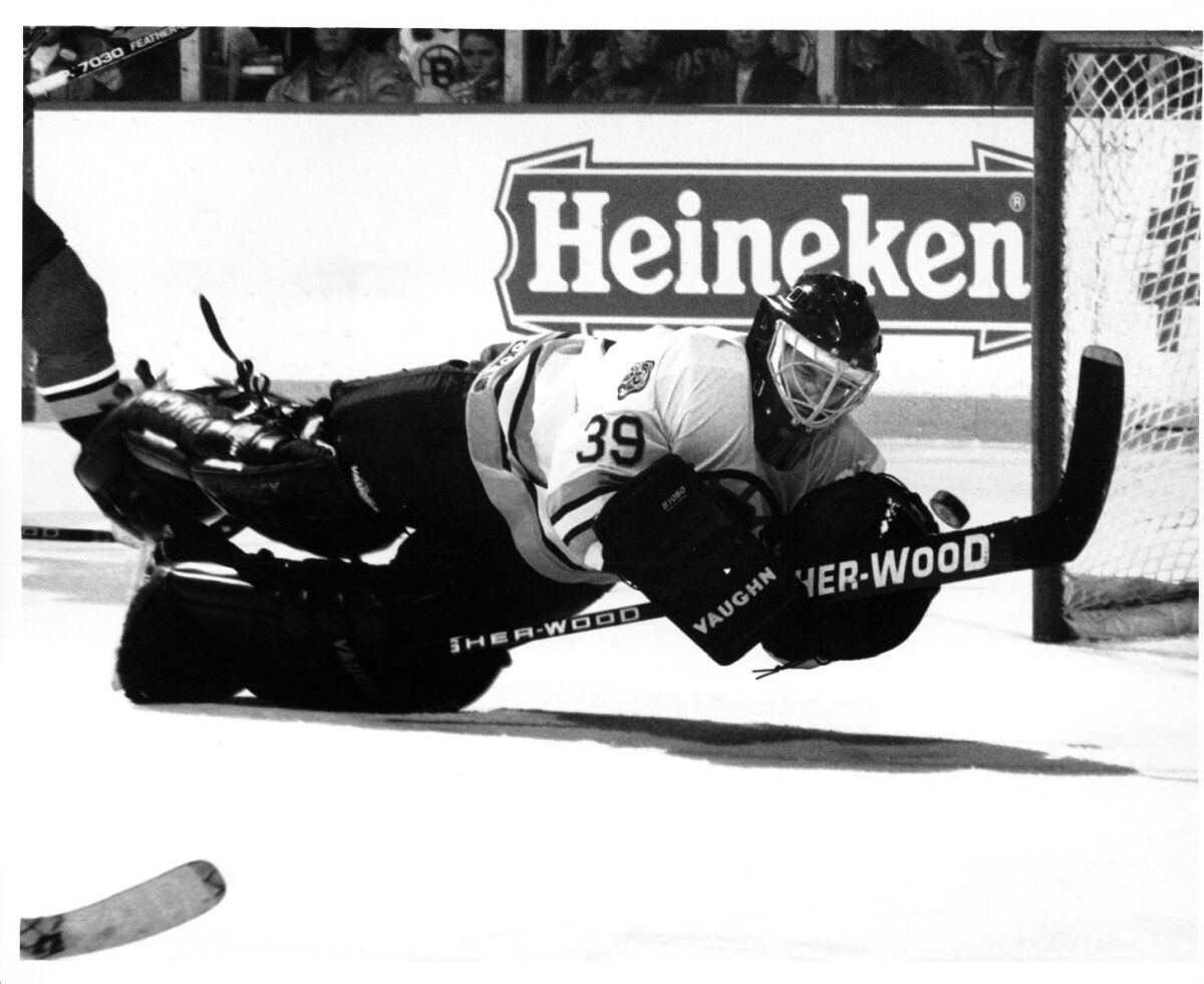 John Blue, the first California native to play goalie in a Stanley Cup playoff game, attempts a diving save.