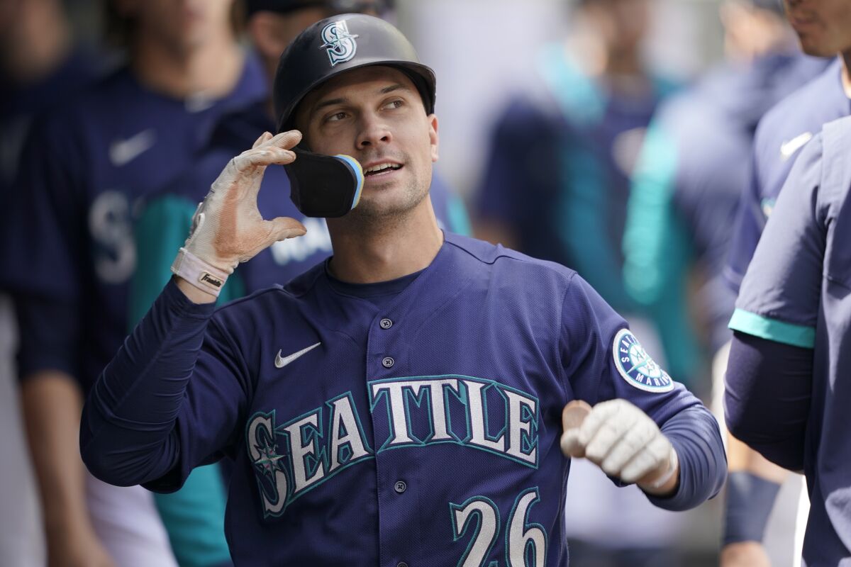 Seattle Mariners' Adam Frazier reacts in the dugout after he scored a run on an RBI-single hit by Julio Rodriguez during the third inning of a baseball game against the Philadelphia Phillies, Wednesday, May 11, 2022, in Seattle. (AP Photo/Ted S. Warren)