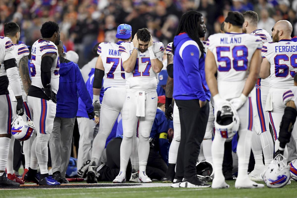 Buffalo Bills quarterback Josh Allen reacts as teammate Damar Hamlin is examined by medical staff.
